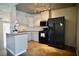 Well-equipped kitchen with stainless steel appliances, white cabinets, and an island for meal preparation at 5732 Heron Ave, Las Vegas, NV 89107