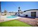 Private backyard pool with stone and artificial turf surround offers a relaxing outdoor space at 5732 Heron Ave, Las Vegas, NV 89107