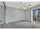 Bedroom featuring modern ceiling fan, sliding glass door, and mirrored closet at 584 Sellers Pl, Henderson, NV 89011