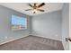 Bedroom with ceiling fan, and large window with blinds and a neutral color palette at 584 Sellers Pl, Henderson, NV 89011