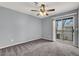 Bedroom featuring modern ceiling fan, sliding glass door, and door to bathroom at 584 Sellers Pl, Henderson, NV 89011