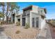 Exterior angle of a two-story apartment with a private balcony, secure gated entry, and low-maintenance desert landscaping at 584 Sellers Pl, Henderson, NV 89011