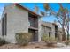 Two-story condo building showcasing a small balcony, chimney and desert landscaping at 584 Sellers Pl, Henderson, NV 89011