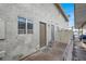 Home exterior with back patio, white fence, gray stucco, and desert landscaping at 584 Sellers Pl, Henderson, NV 89011