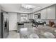 Modern kitchen featuring stainless steel appliances, light gray cabinets, and unique lighting fixture at 584 Sellers Pl, Henderson, NV 89011