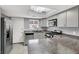 Modern kitchen featuring stainless steel appliances, light gray cabinets, and unique lighting fixture at 584 Sellers Pl, Henderson, NV 89011