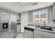 Kitchen featuring stainless steel appliances, light gray cabinets, and a window over the sink at 584 Sellers Pl, Henderson, NV 89011