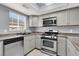 Kitchen featuring stainless steel appliances and light gray cabinets, and a window over the sink at 584 Sellers Pl, Henderson, NV 89011