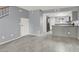 Open living space with staircase, gray walls and tile flooring that leads to the kitchen at 584 Sellers Pl, Henderson, NV 89011