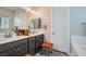 Bathroom with double vanity, modern lighting, and a separate toilet area at 6016 La Coste St, North Las Vegas, NV 89081