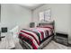 Simple bedroom with grey wood furnishings, neutral tones, and a cozy feel at 6016 La Coste St, North Las Vegas, NV 89081