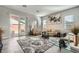 Bright living room with neutral decor, large windows, and sliding glass doors at 6016 La Coste St, North Las Vegas, NV 89081