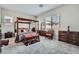 Spacious main bedroom featuring a four-poster bed, soft carpet, and ample natural light at 6016 La Coste St, North Las Vegas, NV 89081