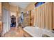 Bathroom featuring a soaking tub and glass-enclosed shower with a walk-in closet at 6105 Port Of Dreams Dr, Las Vegas, NV 89130