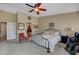 Cozy bedroom with a decorative bed frame and an elegant ceiling fan at 6105 Port Of Dreams Dr, Las Vegas, NV 89130