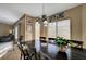 Dining room with a dark wood table and decorative chandelier at 6105 Port Of Dreams Dr, Las Vegas, NV 89130