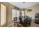 Dining room with dark wood table and decorative chandelier at 6105 Port Of Dreams Dr, Las Vegas, NV 89130