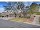 Attractive home with a well-kept lawn, mature trees, a spacious driveway, and an attached three-car garage at 6105 Port Of Dreams Dr, Las Vegas, NV 89130