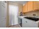 Functional laundry room features a washer, dryer, and overhead cabinets for ample storage solutions at 6105 Port Of Dreams Dr, Las Vegas, NV 89130