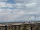 Panoramic back view featuring distant hillside and city views from fenced yard at 6154 Rathbone St, Las Vegas, NV 89166