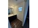 Bathroom with a dark wood cabinet and a framed mirror at 6154 Rathbone St, Las Vegas, NV 89166