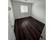 Bedroom with window and dark wood flooring at 6154 Rathbone St, Las Vegas, NV 89166