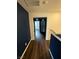 Upstairs hallway with dark wood floors and modern wall paint at 6154 Rathbone St, Las Vegas, NV 89166