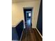 Upstairs hallway with dark wood floors and modern wall paint at 6154 Rathbone St, Las Vegas, NV 89166