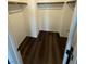 Walk-in closet with wooden bar for hanging clothes and dark wood-look flooring at 6154 Rathbone St, Las Vegas, NV 89166