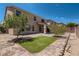 Home's manicured backyard features well-maintained landscaping and a cozy covered patio at 6250 Sierra Knolls Ct, Las Vegas, NV 89139