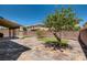 A backyard featuring a covered patio, turf, trees and brick pavers at 6250 Sierra Knolls Ct, Las Vegas, NV 89139