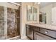 Modern bathroom featuring a glass-enclosed shower and elegant vanity with dual mirrors at 6250 Sierra Knolls Ct, Las Vegas, NV 89139