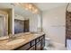 Bathroom featuring a bathtub-shower combo, double sinks, marble counter tops, and a large mirror at 6250 Sierra Knolls Ct, Las Vegas, NV 89139