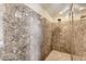 Modern bathroom shower with stunning gray stone-look walls and flooring and a rainfall shower head at 6250 Sierra Knolls Ct, Las Vegas, NV 89139