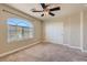 Carpeted bedroom featuring a ceiling fan and a window with curtains for privacy at 6250 Sierra Knolls Ct, Las Vegas, NV 89139