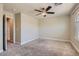 Large, carpeted bedroom featuring a ceiling fan, neutral walls, and natural light from the window at 6250 Sierra Knolls Ct, Las Vegas, NV 89139