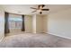 Carpeted bedroom with a ceiling fan and a window for natural light and neighborhood views at 6250 Sierra Knolls Ct, Las Vegas, NV 89139