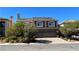 Two-story home featuring a two-car garage and a professionally landscaped front yard at 6250 Sierra Knolls Ct, Las Vegas, NV 89139