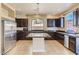 Bright kitchen featuring a stainless steel refrigerator and dark wood cabinets at 6250 Sierra Knolls Ct, Las Vegas, NV 89139