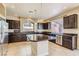 Well-equipped kitchen featuring dark cabinetry, granite countertops and island at 6250 Sierra Knolls Ct, Las Vegas, NV 89139