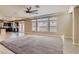 Open-concept living room with tile flooring, plush rug, and natural light through large windows at 6250 Sierra Knolls Ct, Las Vegas, NV 89139