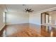 A large living room with wood flooring, a ceiling fan, natural light, and neutral walls at 6250 Sierra Knolls Ct, Las Vegas, NV 89139