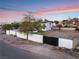 Modern home behind a wall with a gate, showcasing a spacious lot at 6885 Stone Dr, Las Vegas, NV 89110