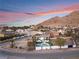 Modern home with a pool and a scenic mountain backdrop at 6885 Stone Dr, Las Vegas, NV 89110