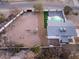 Aerial view of a home with a pool and large undeveloped lot, offering expansion potential at 6885 Stone Dr, Las Vegas, NV 89110