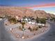 Stunning aerial view of a modern home nestled in the mountains, showcasing a beautifully landscaped yard at 6885 Stone Dr, Las Vegas, NV 89110