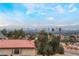 Aerial view showcasing a home with panoramic city and mountain views at 6885 Stone Dr, Las Vegas, NV 89110