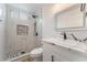 Modern bathroom with marble tile, a large mirror, and black accents at 6885 Stone Dr, Las Vegas, NV 89110