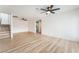 Bright living room with light wood floors and ceiling fans at 6885 Stone Dr, Las Vegas, NV 89110