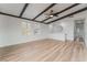 Living room with vaulted ceiling, wood floors, and large windows at 6885 Stone Dr, Las Vegas, NV 89110